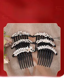 Detail view of five classical hair combs with pearls and rhinestones on satin fabric