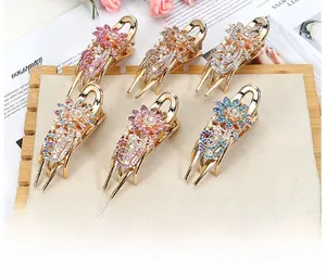 Detailed set of 6 floral rhinestone hair clips with gold alloy base on a jewelry board