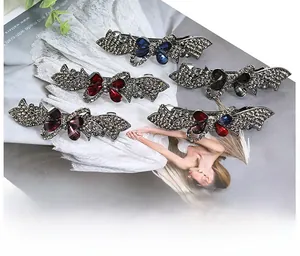 Detail of vintage bow hair clips with grey rhinestones and colorful crystal centerstones