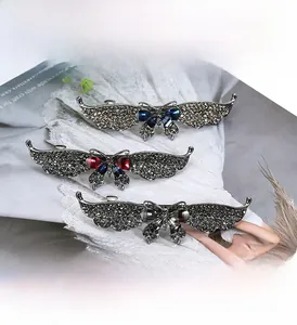 Detail of vintage butterfly hair clips with grey rhinestones and colorful gemstones