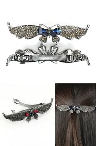 Detailed view of a vintage butterfly spring hair clip with sparkling rhinestones and wings