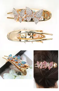 Detail of golden alloy butterfly hair clip featuring sparkling rhinestones and duckbill grip