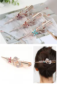 Detail view of rhinestone butterfly hair clips with rose gold plating and crystal accents