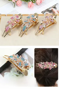 Detailed view of floral hair clip featuring sparkling rhinestones on polished alloy base