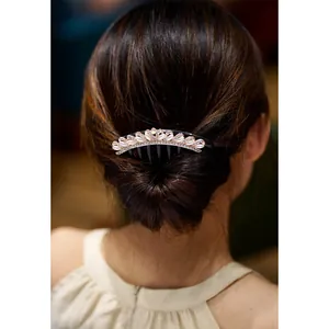 Elegant hair comb with white pearls and rhinestones on deep brown hair updo styling