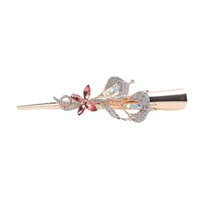 Rose gold bow hair clip featuring pink gemstone flowers and sparkling white rhinestones