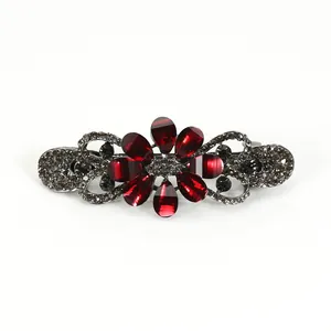 Vintage hair clip featuring red teardrop gemstone flower and grey rhinestones on metal