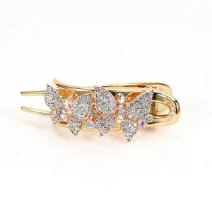 Elegant gold butterfly hair claw clip with white and iridescent rhinestones on white background