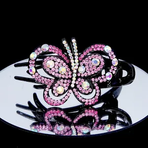 Barrette papillon élégante avec cristaux roses sur une base noire mate