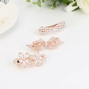 Three-piece rose gold hair clip set with white imitation pearls, bow and floral designs