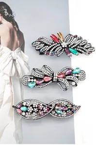 Macro detail of alloy bow hair clips with rhinestones and colored gemstones
