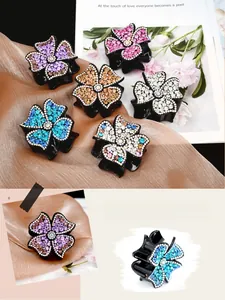 Detail of four-leaf floral hair claws with colorful rhinestones and resin base set