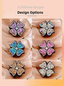 Detail of six colorful floral hair claws with rhinestones on silk background
