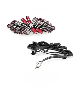 Detail view of bow hair clip with pink rhinestones and red teardrop crystals