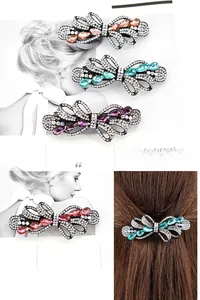 Detail of elegant crystal bow hair clip with colorful teardrop stones in four colors