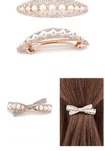 Detail view of pearl and rhinestone bow hair clips with rose gold metal base