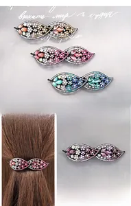 Detail of elegant alloy hair clip with multicolored rhinestones in leaf design