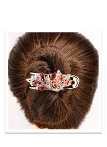 Detail of flower hair claw with red rhinestones on gold alloy base for styling