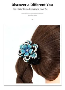 Detail of luxury rhinestone flower hair tie on braided brown hair with velvet band