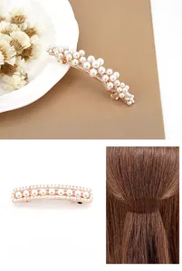 Detailed view of elegant gold hair clip featuring white pearls and rhinestone accents