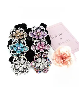 Detail of six sparkling rhinestone flower hair ties in multiple colors with velvet base