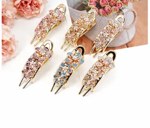 Close-up of six-piece set rose gold floral hair clips with colorful sparkling rhinestones