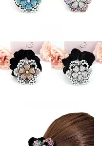 Detail of sparkling rhinestone flower on a soft black velvet hair tie for women