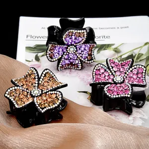 Elegant four-leaf flower hair claw clip with colorful rhinestones on black resin base