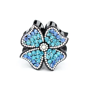 Elegant four-petal flower hair claw clip with sparkling blue and white rhinestones
