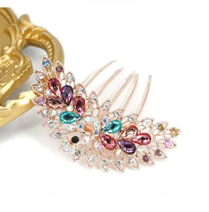 Detail of vintage peacock hair comb with colorful rhinestones and gold alloy teeth