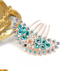Close-up of vintage peacock hair comb with multicolored rhinestones on rose gold plating
