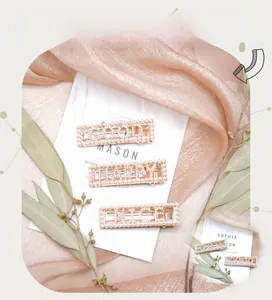Detailed view of three rose gold hair clips with white pearls and sparkling rhinestones