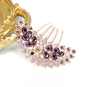 Macro shot of peacock hair comb with purple marquise rhinestones on a gold alloy base