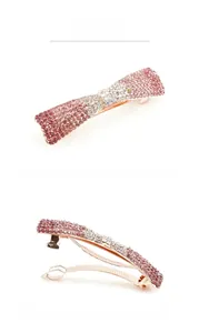 Detail view of spring hair clip with pink and white rhinestones on rose gold metal base