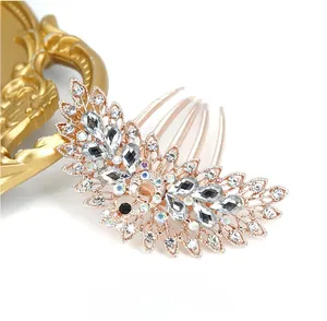 Detailed view of rose gold peacock hair comb with rhinestones on minimal background