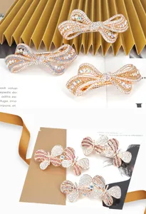Macro detail of butterfly hair clip featuring colorful rhinestones and gold alloy plating