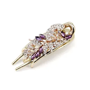 Floral crystal hair claw with purple rhinestones and gold base for elegant hairstyles