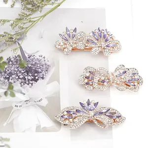Three-piece purple crystal and rose gold hair clip set with rhinestones and floral design