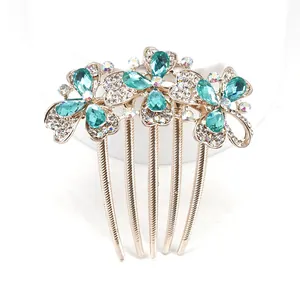 Elegant gold flower hair comb with blue crystals and tassels for bridal hairstyling