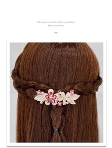 Detail of rose gold flower spring clip with pink crystals on a braided hairstyle