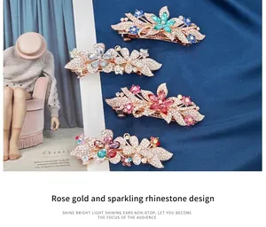 Detail of rose gold flower hair clips with colorful crystals on blue velvet background