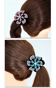 Detailed view of floral hair ties with sparkling pink and blue rhinestones on velvet band
