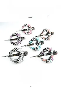Detail of heart-shaped hair clips with sparkling rhinestones and crystal accents