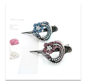 Detail view of crystal rhinestone hair clip with flower and hollow ring design