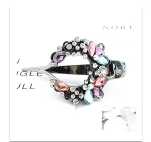 Detail of vintage duckbill hair clip with colorful crystal rhinestones and black alloy finish