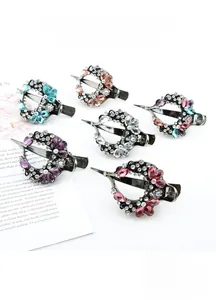 Flat lay of elegant crystal vine heart hair clips in six assorted colors on white background
