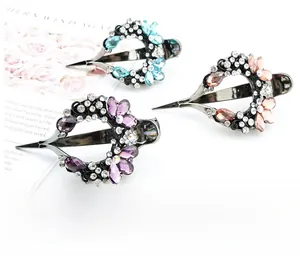 Detailed macro view of three sparkling rhinestone crystal hair clips in various colors