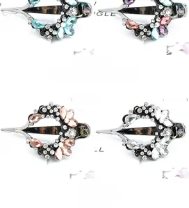 Detailed macro view of four colorful rhinestone flower hair clips on black metal bases