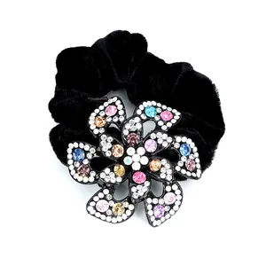 Elegant black velvet floral hair scrunchie with colorful rhinestones on white background