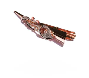Detailed view of rose gold morning glory hair clip with sparkling white crystals